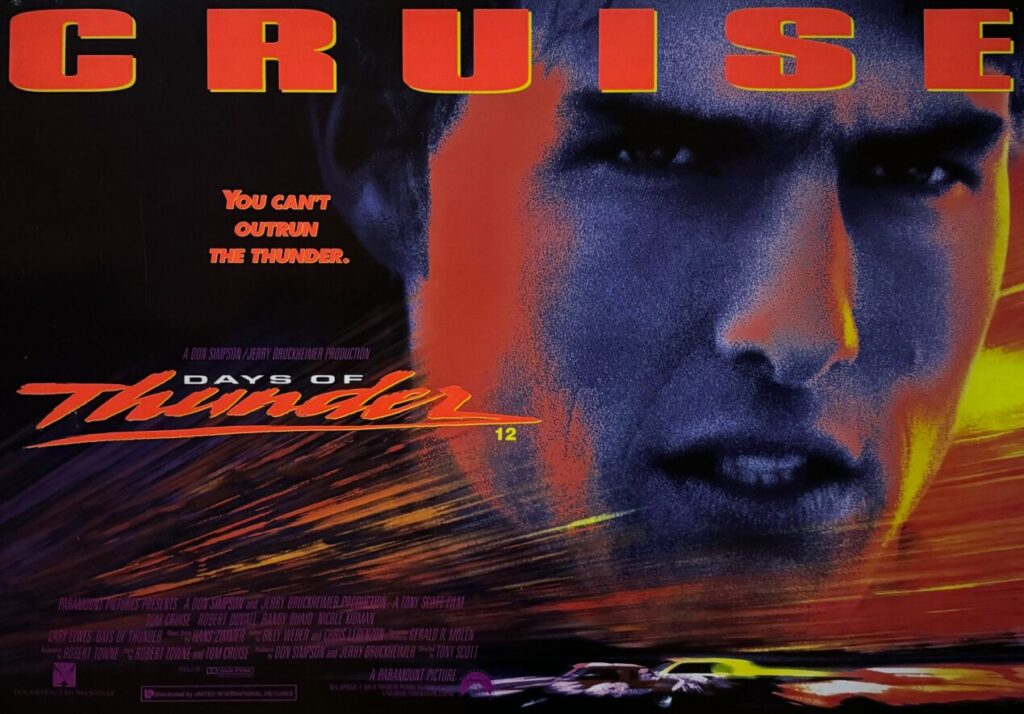 6152FFCD-3A1B-47BF-AD8F-927C03585968 | GotchaMovies Close-up of a colorful Days of Thunder poster featuring Tom Cruise's face and a large red title across the top.