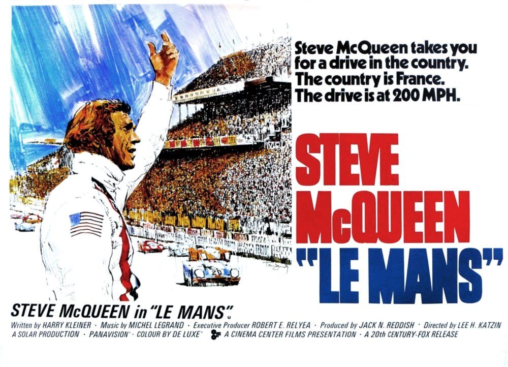 image | GotchaMovies Steve McQueen poster for Le Mans with a racer raising a fist beside a packed grandstand and blue sky backdrop.