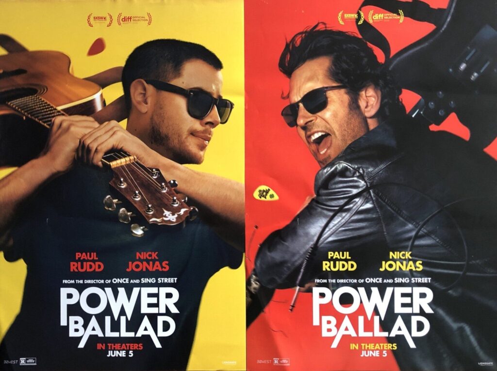 Two side-by-side posters feature Paul Rudd and Nick Jonas with sunglasses; left is yellow, right is red, both promoting Power Ballad.