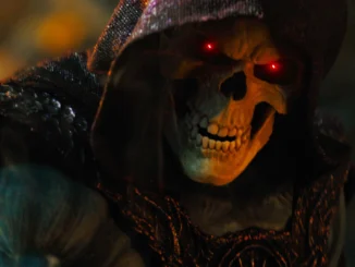 Skeleton in a dark hooded cloak with glowing red eyes, looming menacingly in shadows 11/2024 context-appropriate alt text