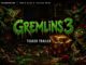 Promotional artwork for Gremlins 3 teaser trailer featuring glowing green title and mischievous gremlins around a holiday gift box.